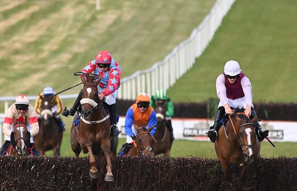 Rebel Waltz (left) and Wild Caprice jump the last together, with the latter blundering under Liam Quinlan
