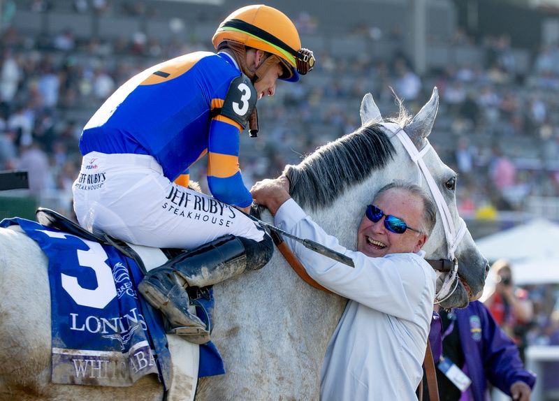 White Abarrio and Irad Ortiz are greeted by winning trainer Rick Dutrow after winning at the Breeders Cup