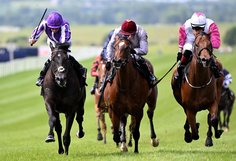 Curragh 25-May-2025Albert Einstein and Ryan Moore (left) win for owners Coolmore and trainer Aidan O'Brien from Power Blue and Andab.Healy Racing