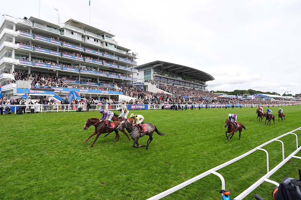 Persica wins race 2 at Epsom under Ryan Moore (purple and white silks)