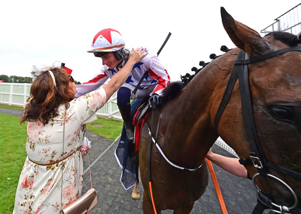 Galway 30-July-2025Jockey Danny Gilligan is greeted by his mother Natalie after his win aboard Western Fold.Healy Racing