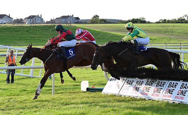 Kilmore Coral leads over the last, with Charity Barnum (nearest) and Whiskey Serenade (inside) close behind