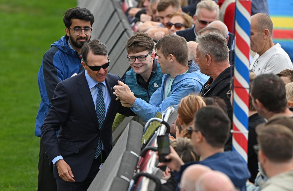 York 20-August-2025Aidan O'Brien signs autographs and takes selfies with racegoers while walking the track.Healy Racing