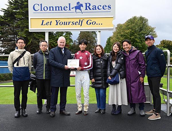Clonmel manager DJ Histon makes a presentation to Ryusei Sakai, with friends