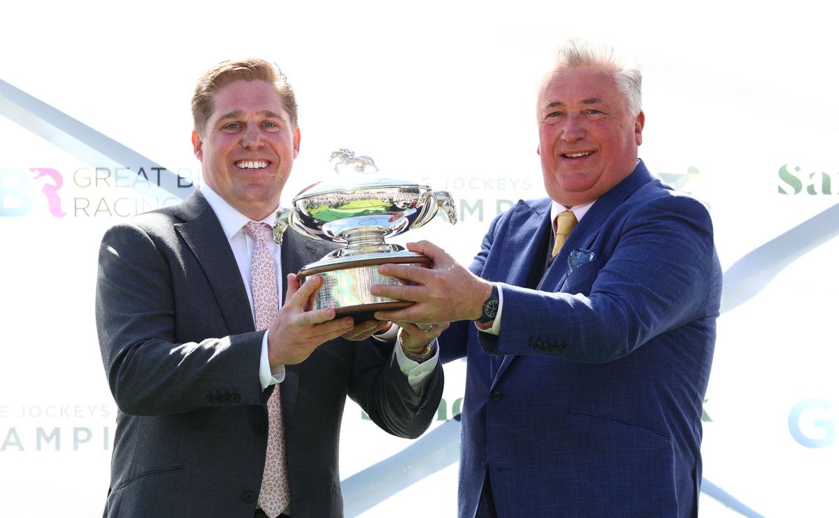  Champion trainer Dan Skelton receives his trophy from Paul Nicholls at Sandown in April
