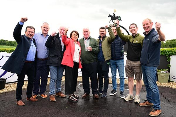 Members of the GeeGees Syndicate celebrate the success of Saunton Surf at Downpatrick today