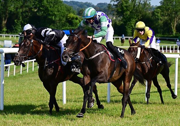 Imarajan and  Paddy Cody (nearest) capitalise as  Carl Millar is inconvenienced by a slipped saddle on Chantilly Wings 