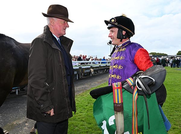 Paul Townend wears the King and Queen of England's silks, talking with Willie Mullins 